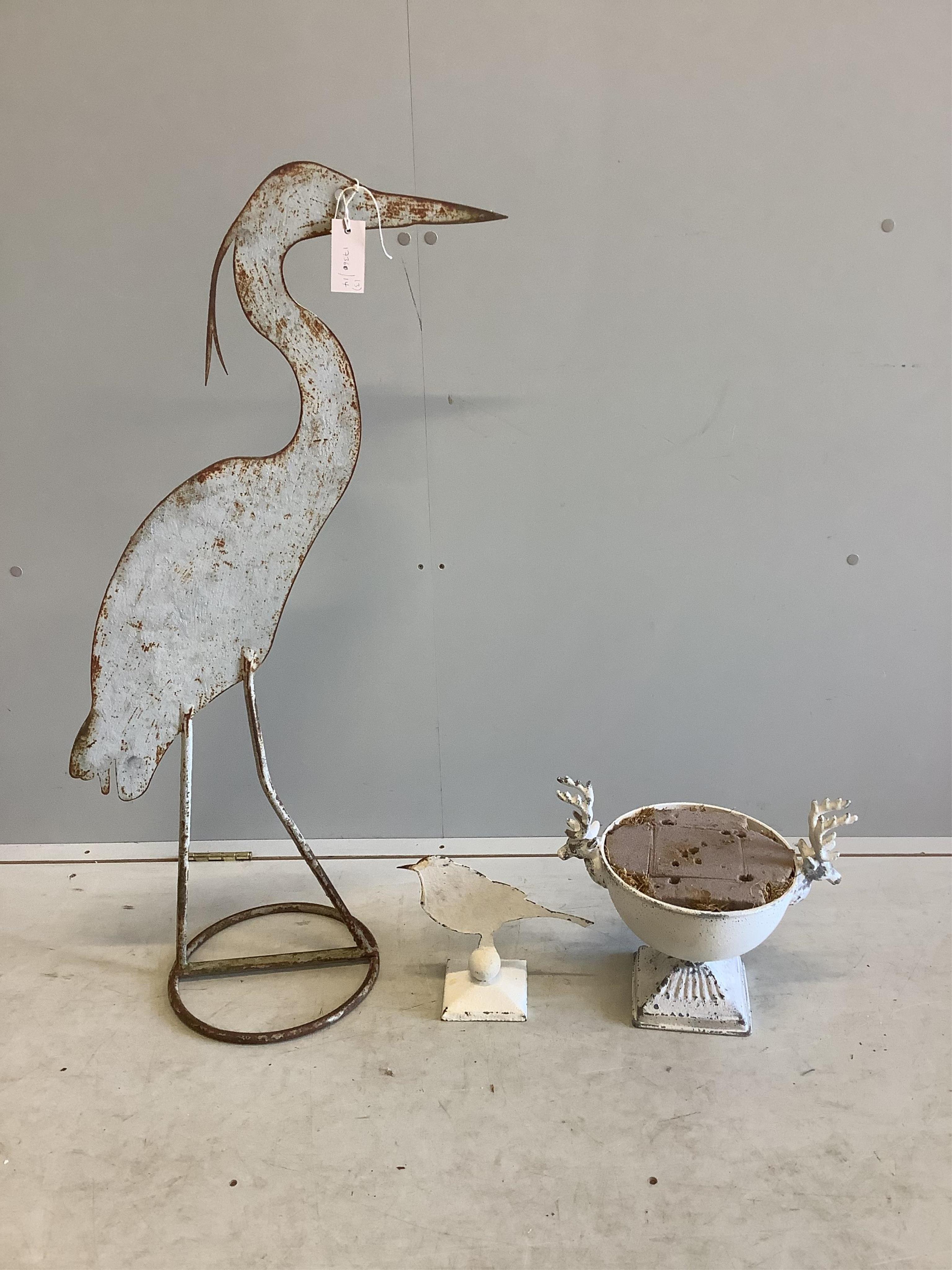 A painted wrought iron heron garden ornament, height 98cm, a metal bird ornament and a stag's head bowl. Condition - fair